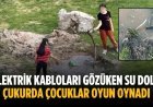Elektrik kabloları gözüken su dolu çukurda çocuklar oyun oynadı